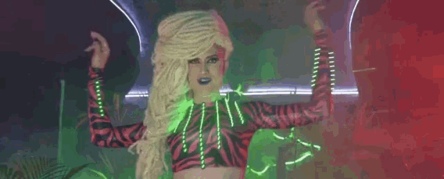 a drag queen with the words shot de catu written above her