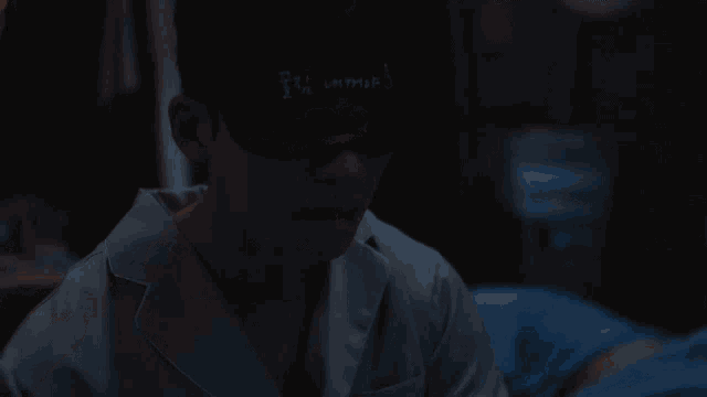 a man wearing a white shirt and a black mask has the word ' i 'm sorry ' written on his face
