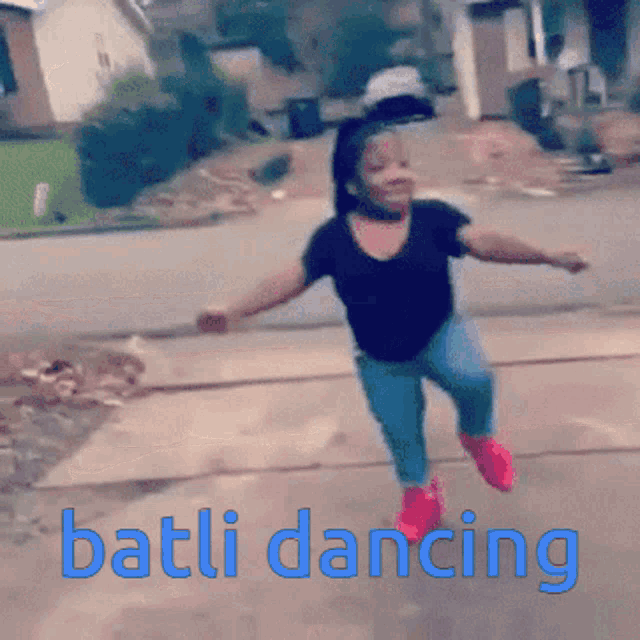 a little girl is dancing on a sidewalk with the words battli dancing below her