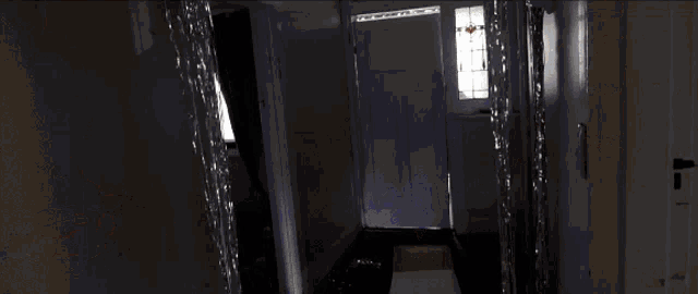 a person in a wheelchair is walking down a hallway with other people
