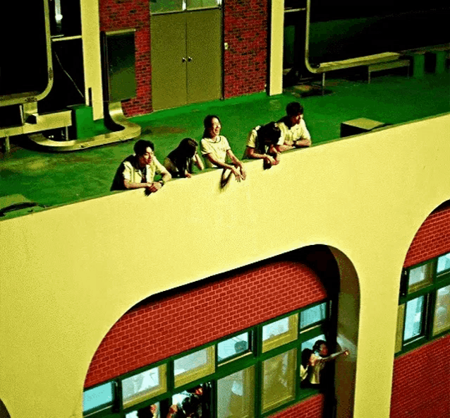 a group of people are looking out of a window