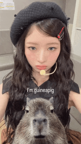 a woman holding a capybara with the words i 'm guineapig on the bottom