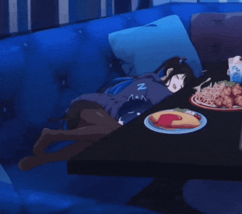 a girl sleeping on a couch with the letter n on her hoodie