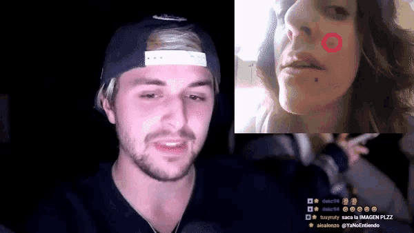 a man in a hat is looking at a woman 's face