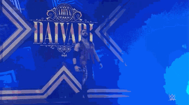 a man is standing in front of a blue background that says daivark