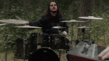 a man playing a drum set with a remo drum head