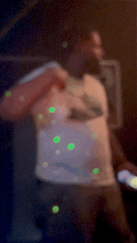 a blurry picture of a man wearing a white shirt with a shark on it