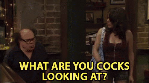 a man and a woman are standing in a room and the woman is asking the man what are you cocks looking at