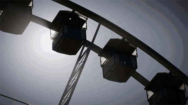 a ferris wheel with the sun shining on it