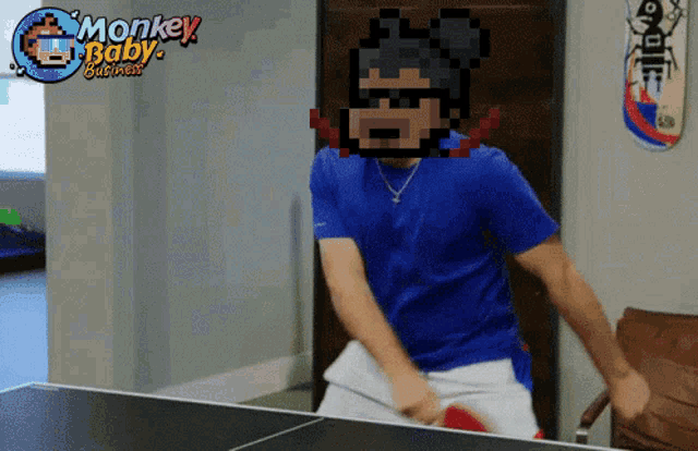 a pixelated image of a man playing ping pong with the words monkey baby business above him