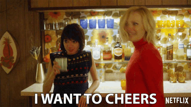 two women standing in front of a bar with the words " i want to cheers " written on the bottom