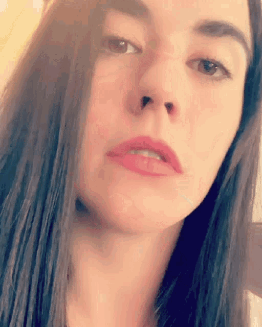 a close up of a woman 's face with her mouth open