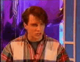 a man in a plaid shirt is looking at something