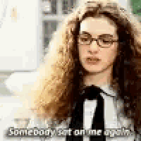 a woman wearing glasses and a black tie is talking to someone .