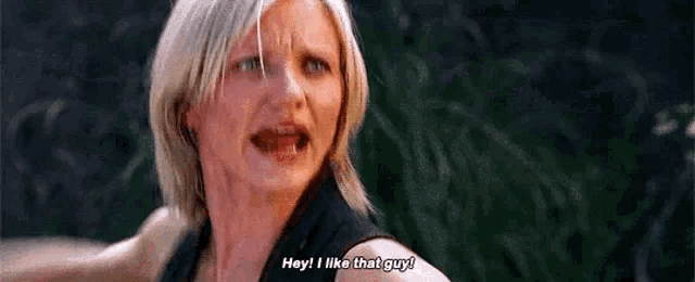 a woman is talking to a man and saying `` hey , i like that guy ! ''