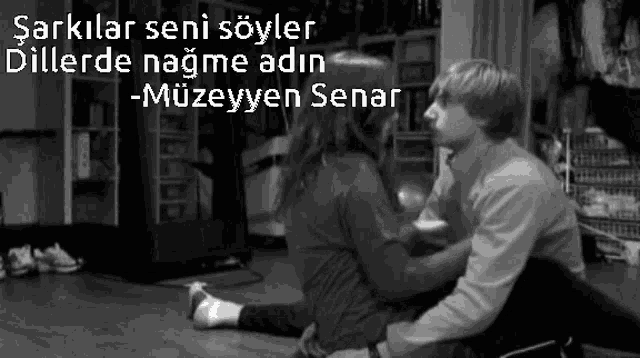 a black and white photo of a man and woman kissing with a caption that says " müzeyyen senar "