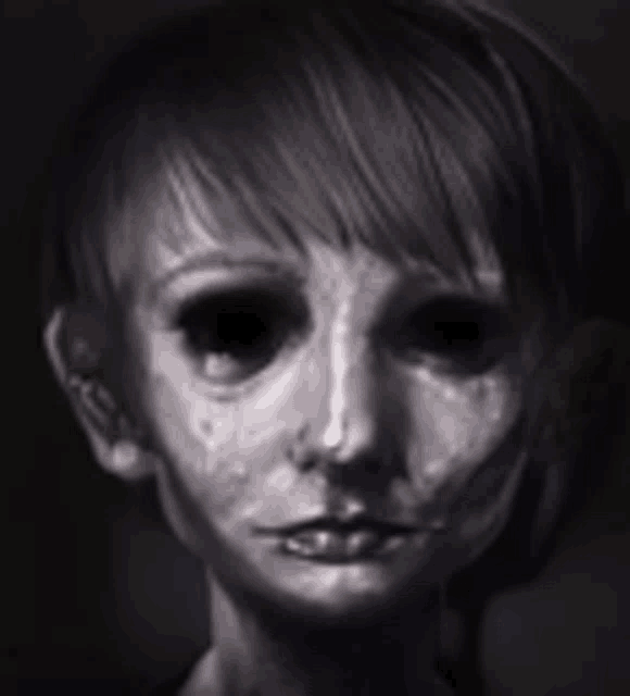 a close up of a person 's face with their eyes closed in the dark .