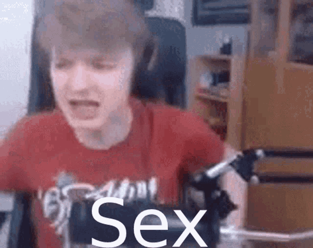 a man in a red shirt with the word sex on his shirt