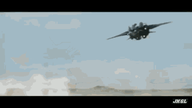 a jet is flying through the air in a desert .