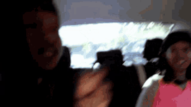 a blurry picture of a man and a woman in a car