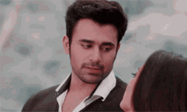 a man and a woman are looking at each other with their eyes closed