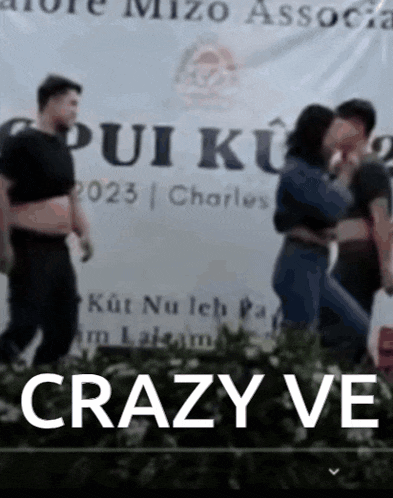 a group of people standing in front of a banner that says crazy ve