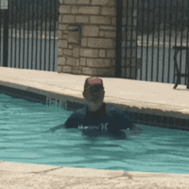 a man in a hurley shirt is in a pool