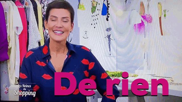 a woman in a blue shirt is smiling in front of a sign that says derien