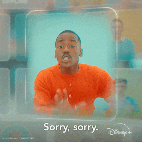 a man in an orange sweater says sorry sorry in front of a disney logo