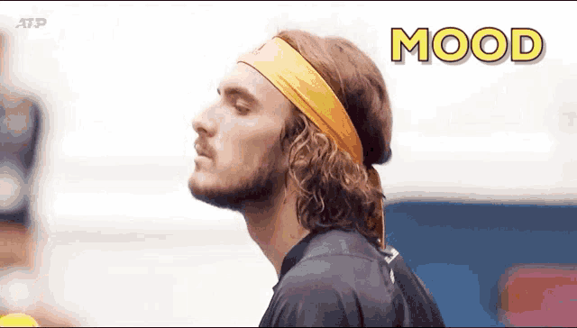 a man wearing a headband and a black shirt with the word mood above him