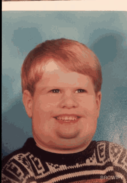 a young boy wearing a sweater that says browify on it