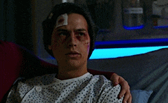 a man in a hospital gown has a bandage on his head
