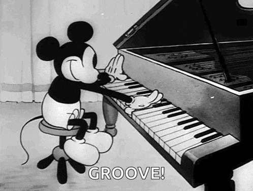 a black and white cartoon of mickey mouse playing a grand piano