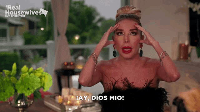 a woman in a feathered dress says ' ay dios mio '