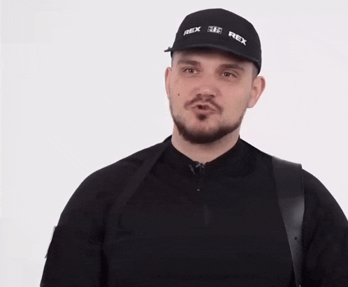 a man wearing a black hat with rex on it