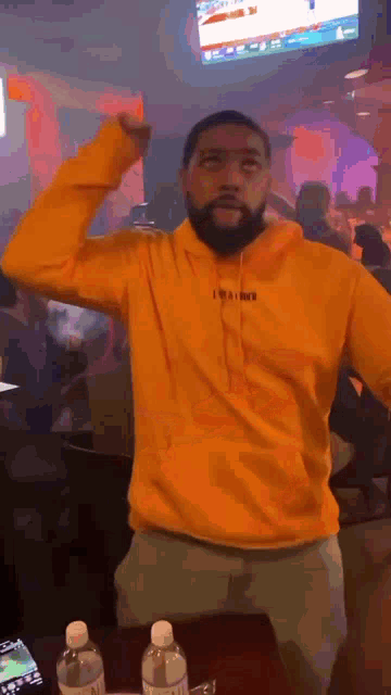a man wearing a yellow hoodie that says i 'm a boxer on it