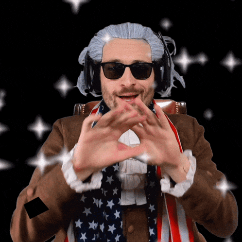 a man in a wig and sunglasses making a heart with his hands