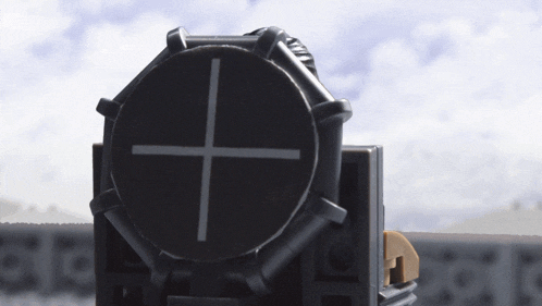 a black circle with a white cross on it