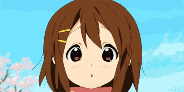 a close up of a girl 's face with a blue sky behind her