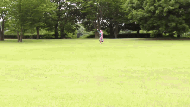a blurry picture of a person in a superhero costume running in a field