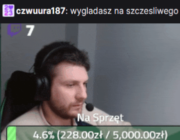 a man wearing headphones is sitting in front of a screen that says na sprot