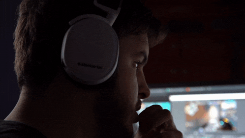 a man wearing a pair of white steelseries headphones