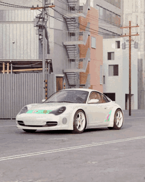 a white sports car is driving down a street in front of a fire escape