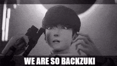 a black and white photo of a person with the words we are so backzuki written above them .