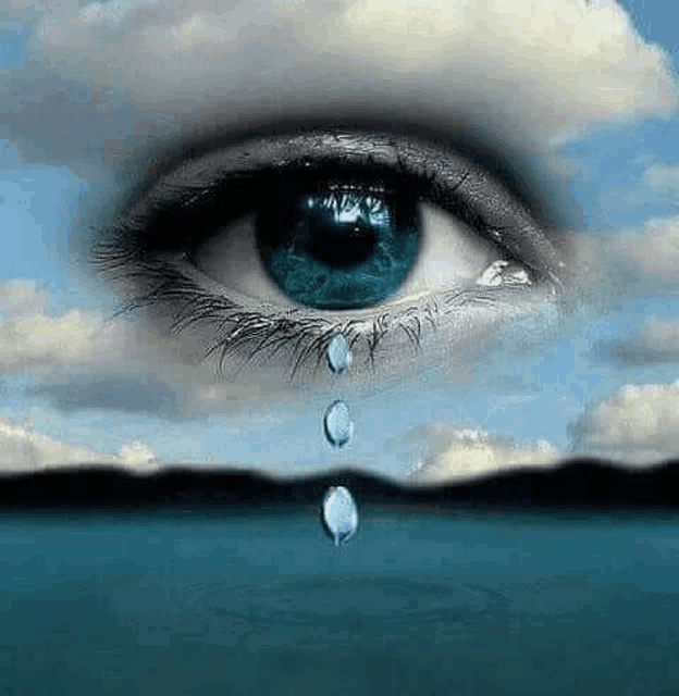 a close up of a woman 's eye with a tear coming out of it