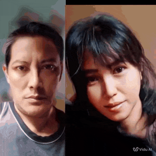 a man and a woman are posing for a picture and the man is wearing a gray shirt