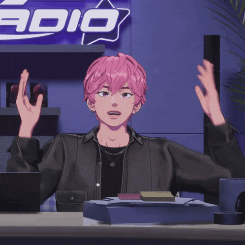a girl with pink hair sitting at a desk in front of a sign that says radio