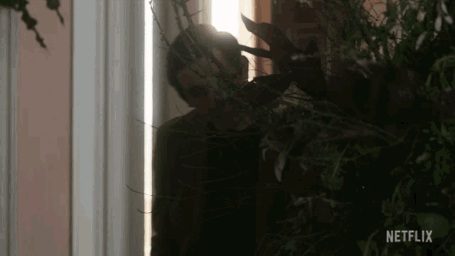 a netflix ad shows a man peeking out of a doorway