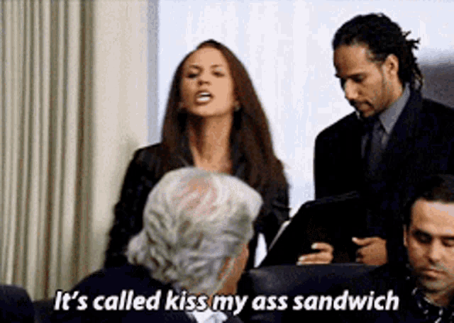 a woman says it 's called kiss my ass sandwich in front of a group of men