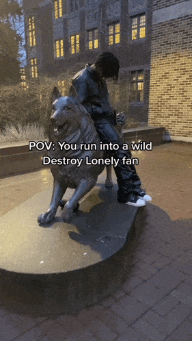 a statue of a man sitting on the back of a lion